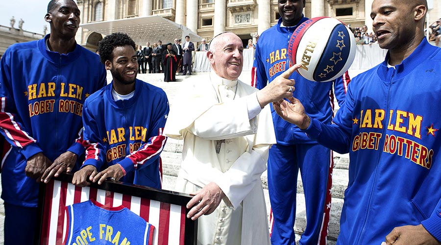 Pope Francis Smiles As He Plays With A Basketball Next To A Member Of The Harlem Globetrotters Basketball Team During The Weekly Audience In Saint Peter's Square At The Vatican